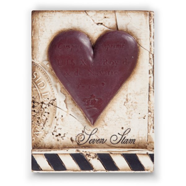 A white sculptural block with a 3D heart and black and white striped banner.
